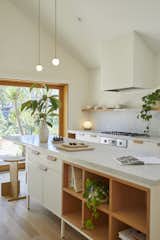 Pink House by And And And Studio kitchen island