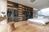 Bedroom, Lamps, Bed, Wardrobe, Chair, Shelves, Ceiling, and Light Hardwood  Bedroom Bed Ceiling Wardrobe Lamps Photos from A Bangkok Home’s Soaring Interiors Are Set Off by a Series of Atriums