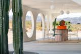 The circular openings frame picturesque views of Joshua Tree National Park, which borders The Meltdown property.