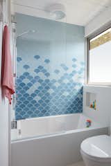 In the kids' bathroom, Fireclay Ogee Drop tile in two shades of blue brings a pop of playful color.