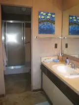 Before: The primary bathroom displayed a dated aesthetic and the shower was leaking into the entry foyer.