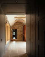 Original stone coursing from the main house is visible through the covered walkway.
