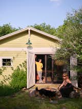The carriage doors open to a side yard with a firepit where Adam and Amanda like to entertain friends and family. "The sliding doors were the biggest ticket item, but really worth the money," says Amanda.&nbsp;