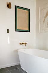 In the main bath, slate flooring is complemented by Restoration Hardware fixtures.