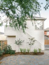 Reconstructing a new two-level studio in place of the standalone garage allowed Divya and Nakul each to have their own workspace. Nakul's garage is below, with Divya's photography studio located above.