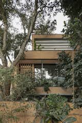 CollectiveProject designed a three-story home in Bangalore, India that is fashioned from blocks handcrafted out of debris from the previous structure on site.  Lush vegetation including mango, avocado, and citrus trees helps the home recede into the background.