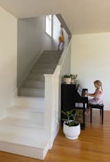 A dip of grey paint on the staircase hints at the updated spaces above.