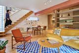 The dining area pendant is a vintage Louis Poulsen piece, and the dining table is from HAY. The dining chairs are a mix of antique wood chairs, a Thonet, and an Eames DCM chair. The lounge chair is a mid-century Norwegian piece from Skarbos.