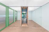 Polycarbonate ceilings frame the entry area and the bedroom doors, allowing light to enter the space and bounce off the mirrored storage closets.