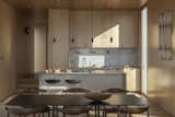 The kitchen contains countertops and backsplash in stainless steel, which offers a muted softness to the space. "The stainless steel has a very thin profile, so it continues that theme of delicate, light expression which we wanted for the house,