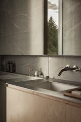 In the bathroom, stainless steel countertops and porcelain tiles bring a sense of muted softness.