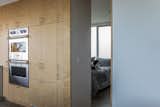 The door to the primary suite, made of birch plywood, looks like another cabinet front when shut.