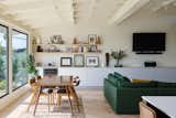 The floors were replaced with a light oak in a herringbone pattern, and built-in casework from Reform added to provide additional storage. The sofa is by A.Rudin/Evan Spencer.  Photo 6 of 23 in Before & After: An L.A. Music Producer’s Latest Collab? Turning a Midcentury Into His Family Home