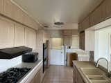 Before: The galley kitchen was dark and cramped with outdated finishes and appliances.