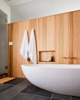 The bath in the primary bath is agape with the taps of the watermark.