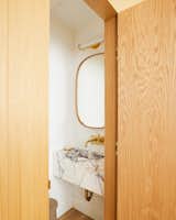 The powder room contains a custom stone sink in marble Lilac source source from ABC stone. "The owners said from the beginning that they wanted to keep their original purple entrance door," Says Otten. "We leaned into and withdraw the elements of purple in the whole house, including a marble with a castor in the powder room and a kitchenette."