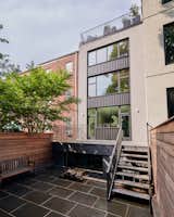 The city house had a small addition on the back that was added in the 1960s, but the designers decided to remove it in favor of creating an open deck immediately from the relocated kitchen.
