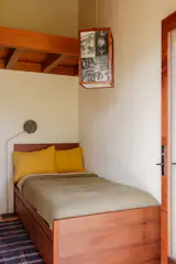 <span style="font-family: Theinhardt, -apple-system, BlinkMacSystemFont, "Segoe UI", Roboto, Oxygen-Sans, Ubuntu, Cantarell, "Helvetica Neue", sans-serif;">In the second bedroom, the Black Mountain College hanging lamp is by Rachel Corry and the floor lamp is by Rico Duenas.</span>