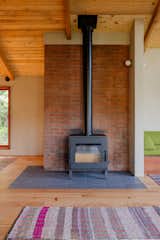 The flooring is old growth Douglas fir which Nick sourced from Good Wood Wood Goods in Portland, Oregon. The Cle Tile flooring around the wood stove is arranged in a midcentury-inspired pattern.