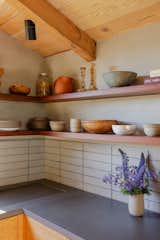 The kitchen counters are cast concrete with an. integrated sink and drain board.