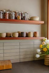 The backsplash tile in the kitchen is Cle Tile. The ceramic dishware is by Julie Cloutier, who also has several ceramic pieces scattered throughout the home.