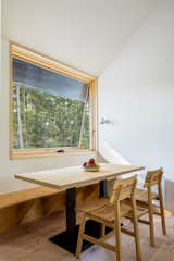 The dining area features a built-in bench and table, both crafted by Island Custom Woodworks.