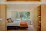 The sleeping area is framed with custom maple casework crafted by local Lopez Island company, Island Custom Woodworks. The brass cabinet pulls are from Schoolhouse, and the wall lamp is by Normann Copenhagen.