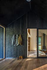 A screened porch encloses the breezeway between the main living area and the sleeping area, providing ample outdoor space for lounging or storing kayaks.