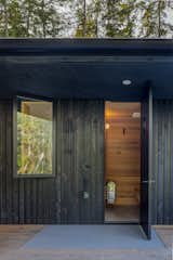 The sauna features its own entrance next to an outdoor shower. The sauna heater is from Harvia, a company based in Finland.
