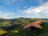 Arquipélago Arquitetos and Mariana Caires designed this timber home hugging the hillside in the Bocaina countryside region of Brazil.
