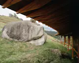 "We were able to create a more welcoming scale within the vastness of the site by positioning the bedroom corridor around the bonsai,