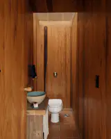 Interior spaces continue the dialogue with natural materials including wood and tile that began on the exterior.