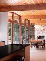 The original stone slab fireplace has been preserved. "Those stones were actually excavated from the site," says Katherine. "We wanted to preserve and enhance the essence of the original structure," adds Andrija.