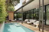 Outside, a covered deck opens to a pool clad in penny tile. "The home is light and airy and really takes advantage of the outdoor spaces,