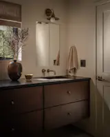 The jack-and-jill bathroom serves both bedrooms. The sconces are by Smile Lamp Works and the faucets and fixtures are by <a href="http://www.jaclo.com">Jaclo</a>.
