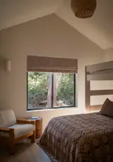 A bunk-bed in the second bedroom can sleep three. The vintage arm chair is from <a href="http://www.casapatina.com">Casa Patina</a> and the rattan pendant lamp is from <a href="http://www.twentyonetonnes.com">Twenty One Tonnes</a>.