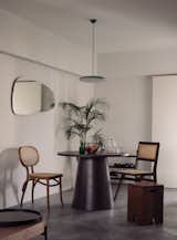 Dark timber and rattan furniture were selected to warm up the cool tones of the home.