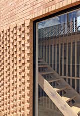 The external monolithic brick volume is relieved and enlivened by different brick patterns and perforations in order to provide solar shading, privacy and compositional balance.