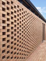 The external monolithic brick volume is relieved and enlivened by different brick patterns and perforations in order to provide solar shading, privacy and compositional balance.