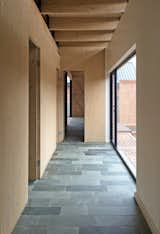 In the private wing, each bedroom opens out onto a small covered veranda.  A restrained interior palette of natural materials, including green limestone, marble and timber provides a rich and inviting tactile experience in contrast with the monolithic brick exterior.   Photo 12 of 13 in BRICK HOUSE by Liani Douglas