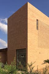 The external monolithic brick volume is relieved and enlivened by different brick patterns and perforations. The tower was a request from the client who sought a space to retreat to where one can view the horizon.