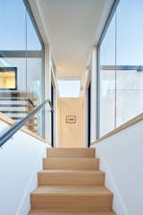 See through flush glazed stairs, looking up through transom and skylight interior vista
