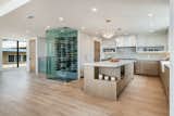 The chef's kitchen includes plenty of counter space, a walk in pantry and artistically-detailed, glass wine cellar and bottle display. 