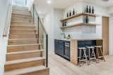 Travel down to the lower entertainment level that features a wet bar (shown here), game room and home theater. 