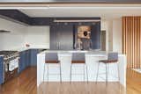 Kitchen cabinetry is navy and white.