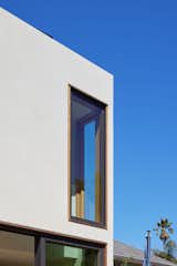 Other openings are simple windows that yield to the monolithic form sheathed in white plaster.