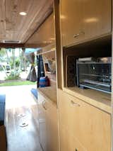 Kitchen Kitchen storage and the small convection oven.  Photo 14 of 15 in The Pennybago by Laurén Ettinger