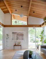 Lighting is dynamic rather than rigid, with undulating placements that add visual interest, accentuate the high geometric windows, and complement the ceiling heights