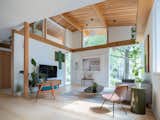 Expansive windows positioned to frame views of trees and sky