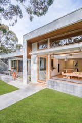 Fixed louvres filter the northern light into the dining room and cast a rhthym of shadows on the ground. 
Large bifold windows are recessed into the blockwork plinth seat allowing diners to sit facing inwards or outwards to the bush garden.